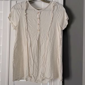Cream colored flowy blouse.
